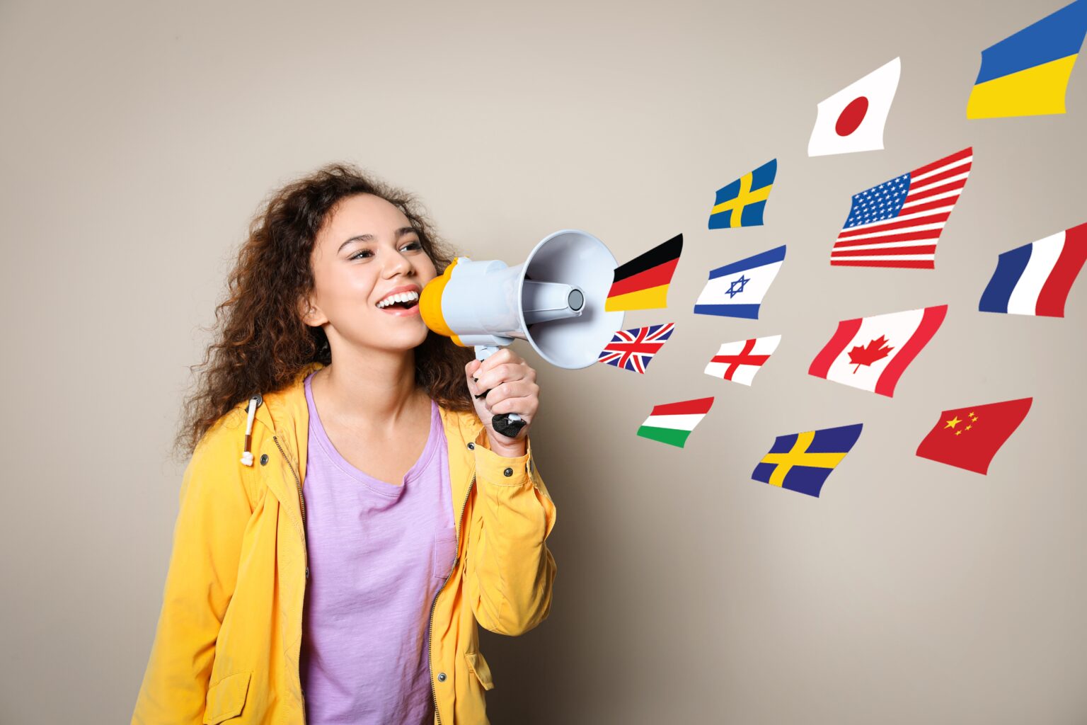 Teeenager holding speaker with nation flags flowing through it