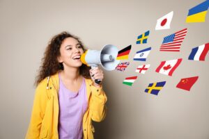 Teeenager holding speaker with nation flags flowing through it