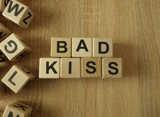 Bad,Kiss,Text,From,Wooden,Blocks,On,Desk